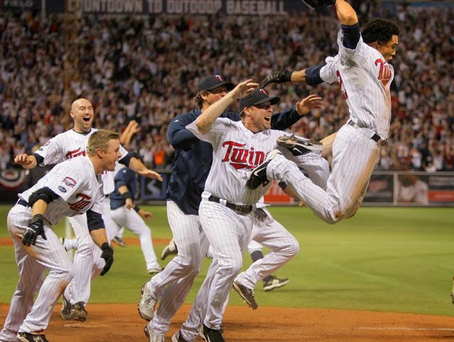 Carlos Gomez, right, and the Twins celebrate their 12th inning win in the tiebreaker game for the AL Central last night.